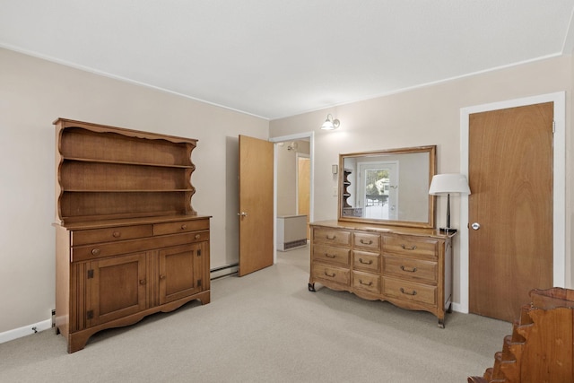 bedroom featuring light colored carpet, baseboards, and a baseboard radiator