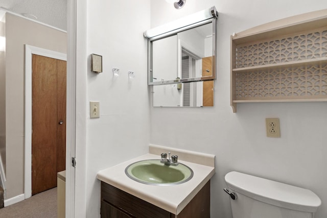 half bathroom featuring toilet and vanity