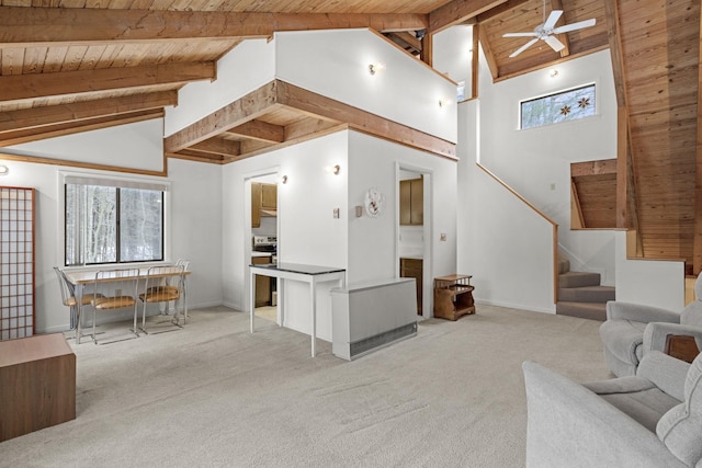 living area featuring a wealth of natural light, stairway, and wood ceiling