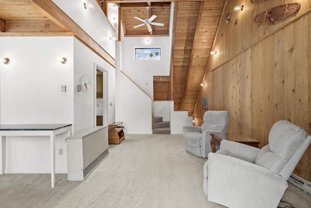 living room featuring a ceiling fan, carpet floors, stairs, wood ceiling, and a baseboard heating unit