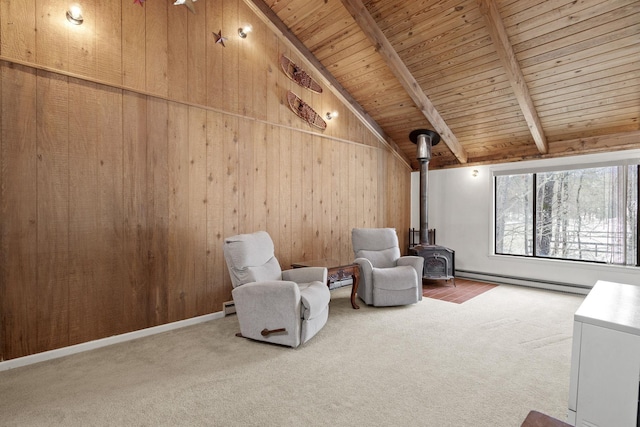 unfurnished room featuring carpet floors, a baseboard radiator, a wood stove, vaulted ceiling with beams, and wood walls