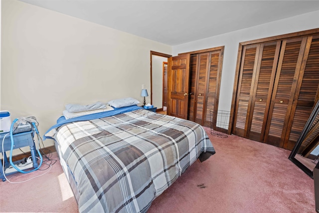 carpeted bedroom featuring multiple closets