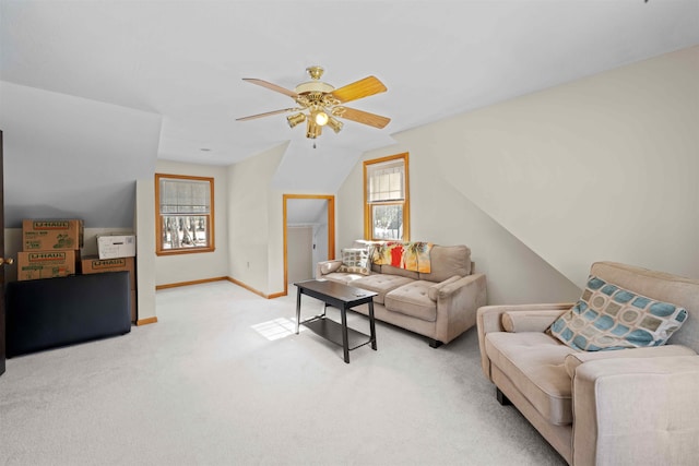 living area featuring baseboards, carpet, lofted ceiling, and ceiling fan