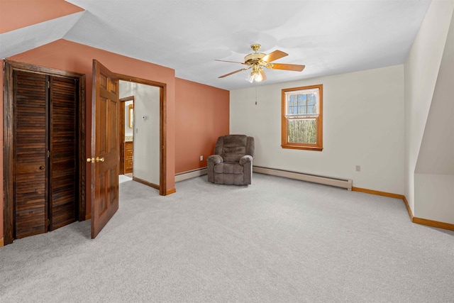 unfurnished room with a baseboard heating unit, carpet, baseboards, and ceiling fan