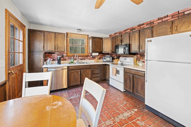 kitchen featuring white appliances, brick floor, ceiling fan, a sink, and light countertops