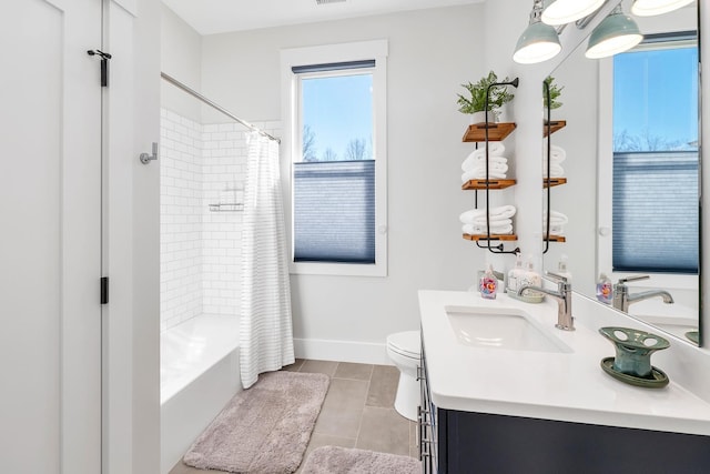 full bath featuring baseboards, toilet, shower / tub combo, tile patterned floors, and vanity