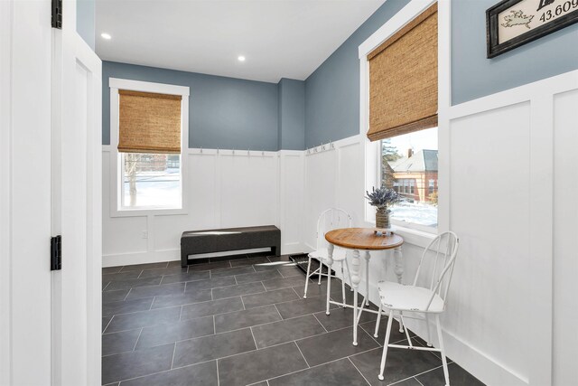 sitting room featuring a decorative wall, recessed lighting, a wainscoted wall, and dark tile patterned flooring