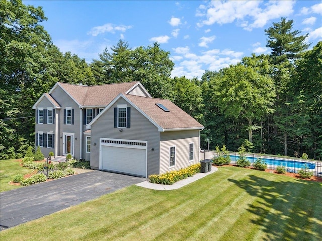 view of front of property featuring a fenced in pool, fence, roof with shingles, a front lawn, and a garage