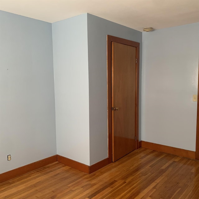 unfurnished room with baseboards and light wood-style floors