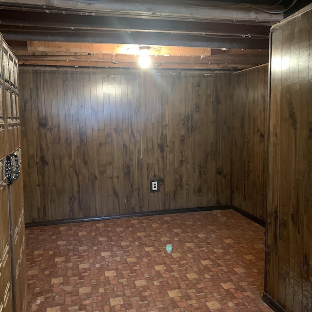 unfinished basement featuring wood walls