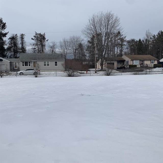 yard covered in snow featuring a garage