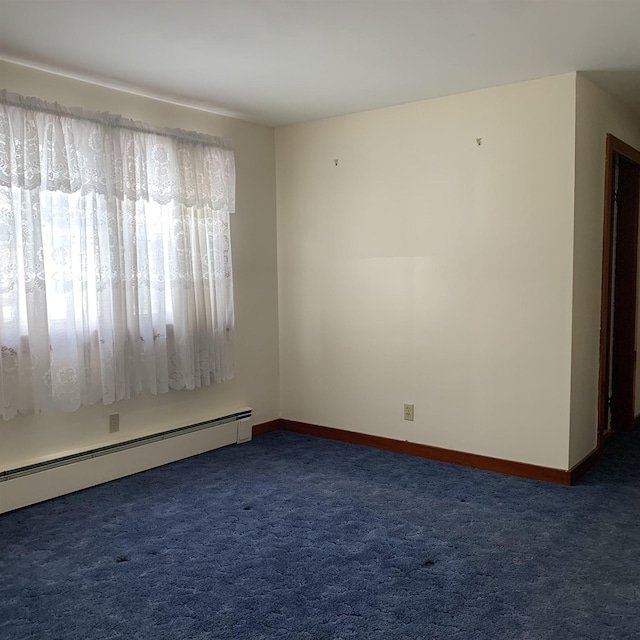 spare room featuring carpet flooring, baseboards, and a baseboard radiator