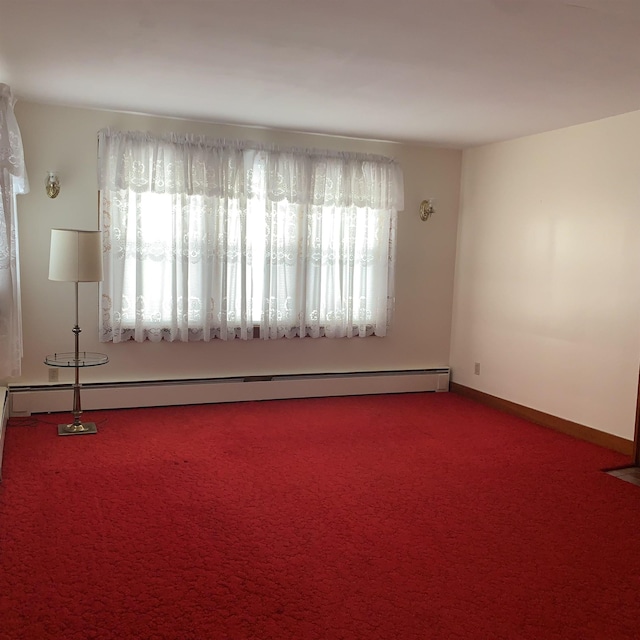 carpeted spare room with baseboards and baseboard heating