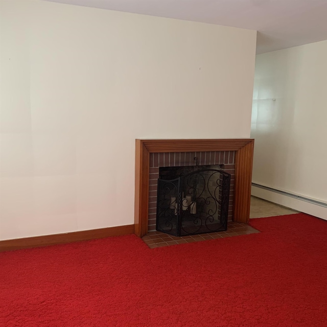 unfurnished living room with a baseboard heating unit, carpet flooring, a fireplace, and baseboards