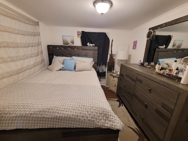 bedroom featuring crown molding and wood finished floors