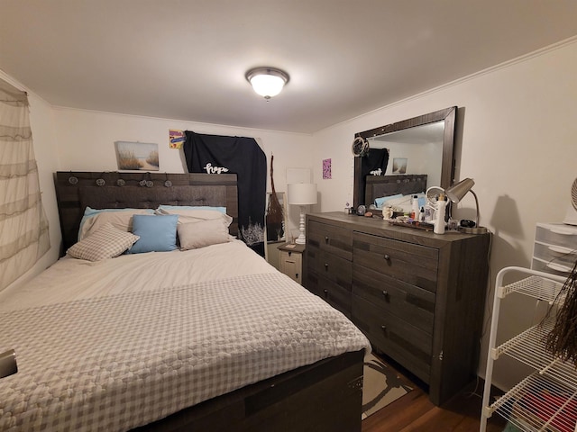 bedroom featuring dark wood-style flooring and crown molding