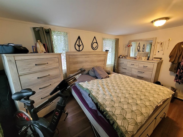 bedroom featuring dark wood finished floors and crown molding