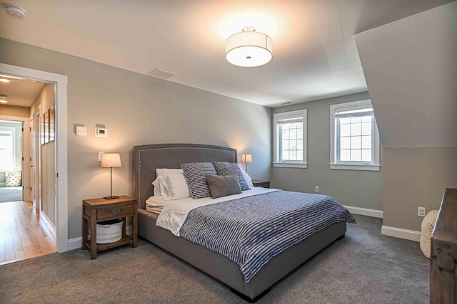 bedroom with carpet flooring and baseboards