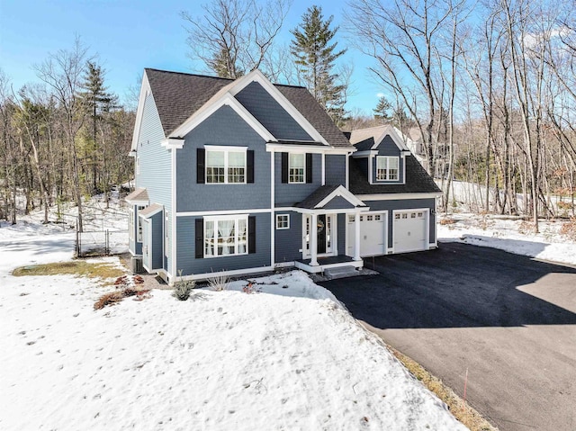 view of front of home with aphalt driveway, a shingled roof, and a garage