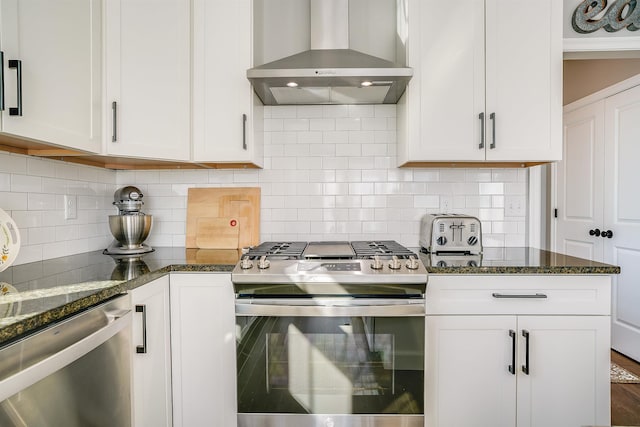 kitchen with stainless steel appliances, wall chimney exhaust hood, and white cabinetry