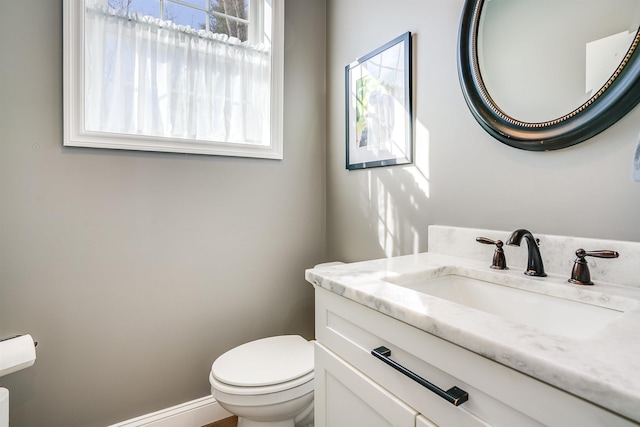 half bath featuring toilet and vanity