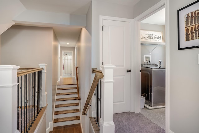 stairway featuring washer / clothes dryer and wood finished floors