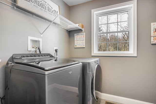 laundry room with washer and dryer, laundry area, and a wealth of natural light