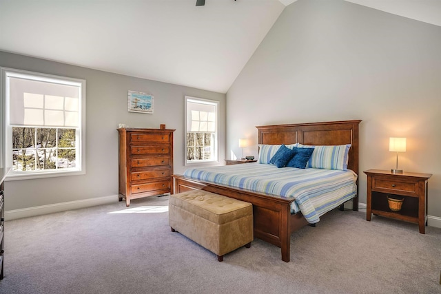 bedroom featuring light carpet, high vaulted ceiling, and baseboards