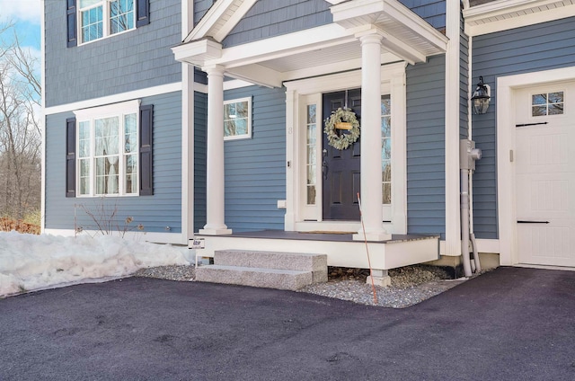 view of exterior entry featuring a porch