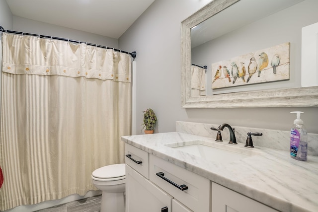 bathroom with toilet, vanity, and a shower with curtain