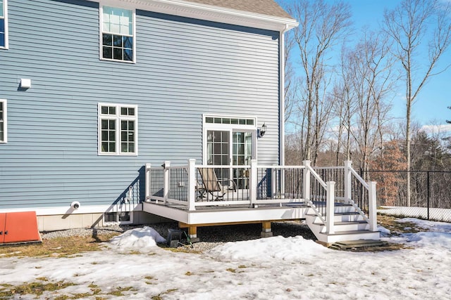 snow covered house with a deck