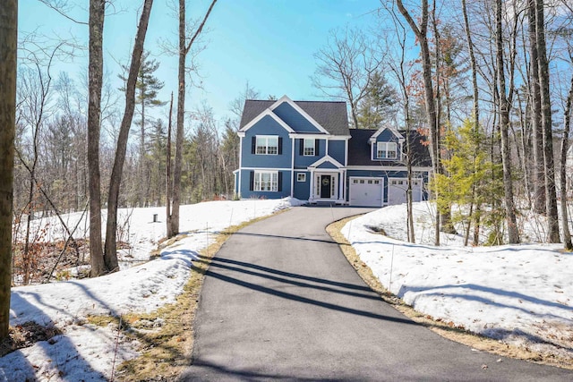 view of front of property featuring aphalt driveway and an attached garage