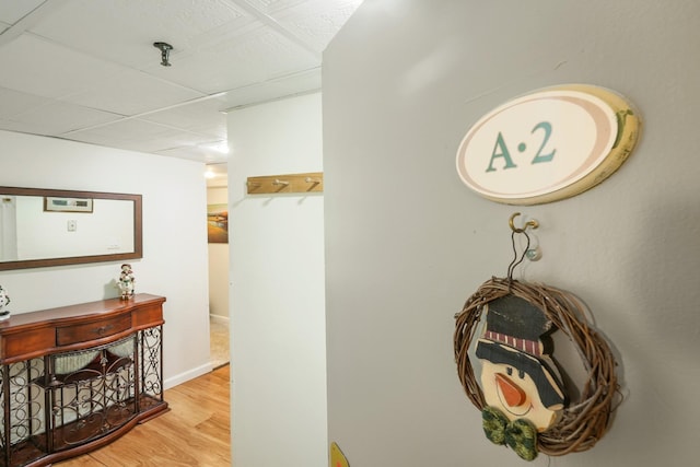 hall featuring baseboards and wood finished floors