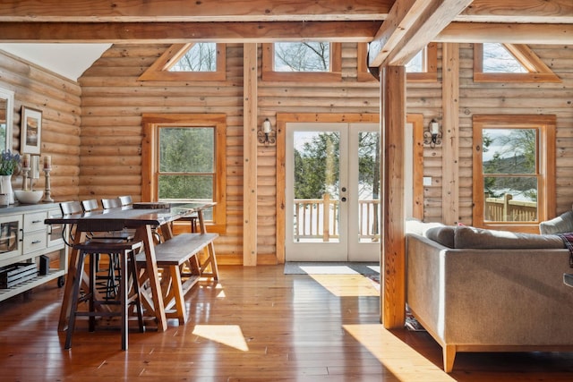 dining space featuring a wealth of natural light, french doors, high vaulted ceiling, and dark wood-style floors