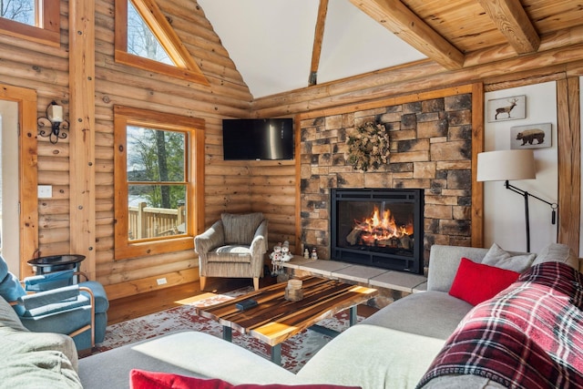 living room with a stone fireplace, beamed ceiling, high vaulted ceiling, and wood finished floors