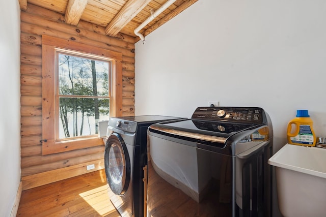 washroom with hardwood / wood-style flooring, a sink, separate washer and dryer, wood ceiling, and laundry area