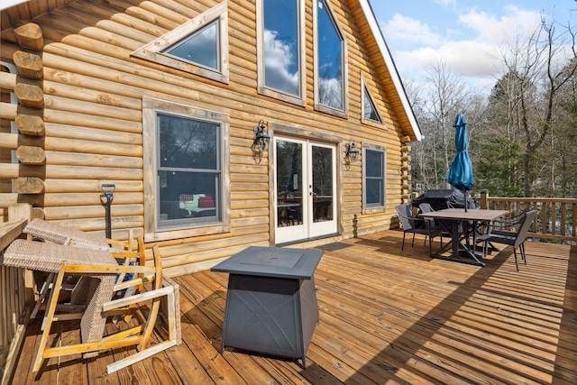 deck featuring outdoor dining space and french doors