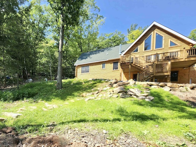 rear view of property featuring stairs and a deck