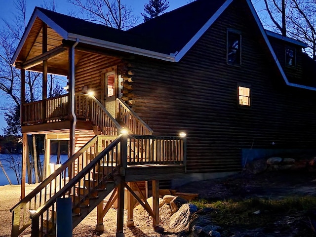 view of side of property featuring stairs