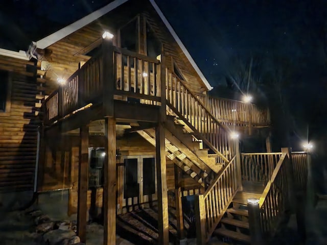 exterior space with log siding, french doors, and stairs