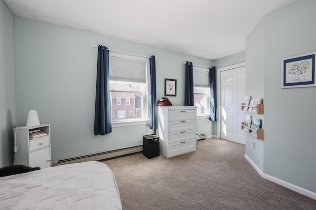 bedroom with a closet, light colored carpet, baseboards, and a baseboard radiator