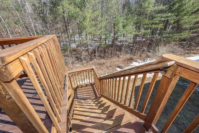 wooden deck featuring a forest view