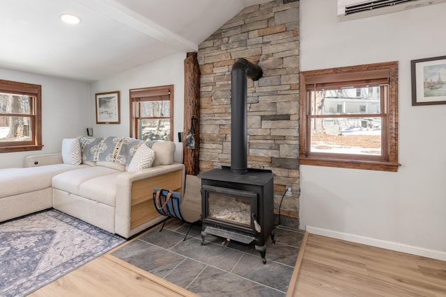 living room featuring lofted ceiling, a wood stove, an AC wall unit, and wood finished floors