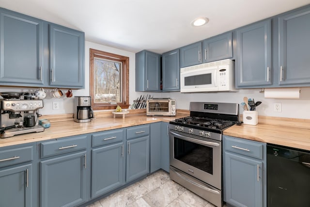 kitchen featuring white microwave, blue cabinetry, stainless steel range with gas cooktop, a toaster, and black dishwasher