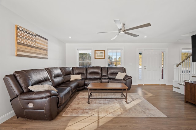 living area featuring recessed lighting, baseboards, wood finished floors, and stairs