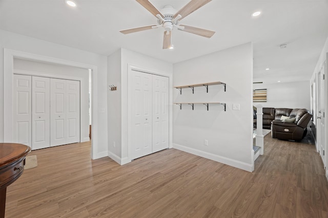 interior space featuring recessed lighting, wood finished floors, and baseboards