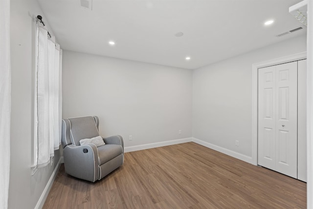 sitting room with recessed lighting, wood finished floors, visible vents, and baseboards