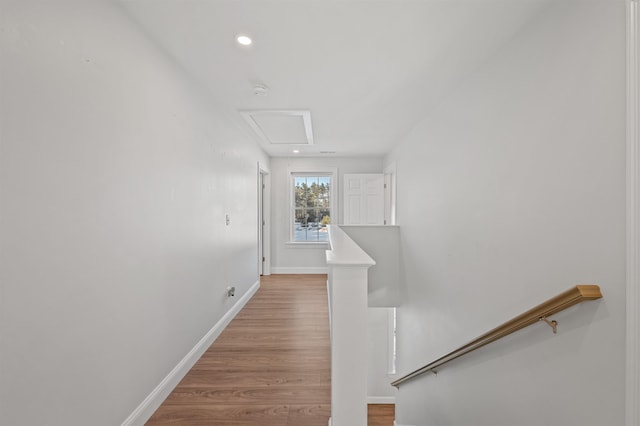 hall featuring recessed lighting, light wood-type flooring, an upstairs landing, and baseboards