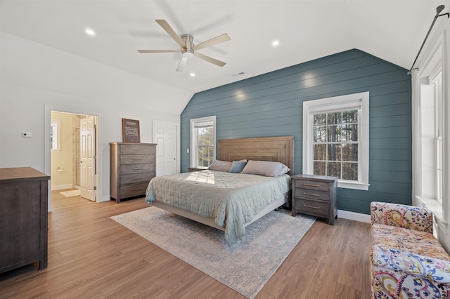 bedroom featuring baseboards, lofted ceiling, ceiling fan, and light wood finished floors