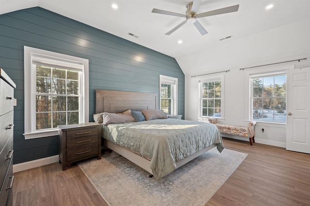 bedroom featuring visible vents, lofted ceiling, and wood finished floors